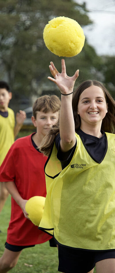 Sport Berkley Student Stands Outside Holding a Pingpong Paddle