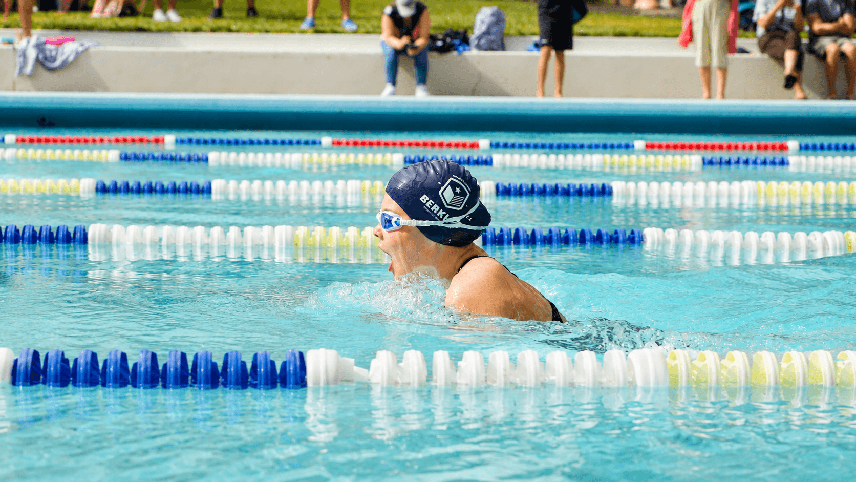 A Berkley swimmer competing in an outdoor pool